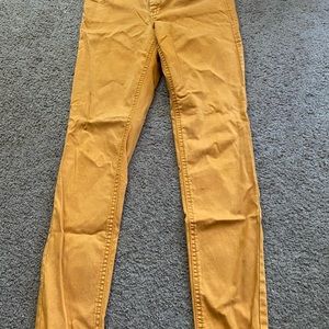 a pair of mustard yellow jeans